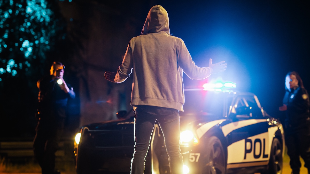 Suspect Raising Hands in Compliance in front of two police officers