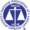 Logo of the National Association of Criminal Defense Lawyers (NACDL) featuring balanced scales inside a blue circle, with “NACDL” above the scales and “1958” below, surrounded by the association’s name.